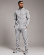 Airavon Model wearing a light grey tracksuit, studio view
