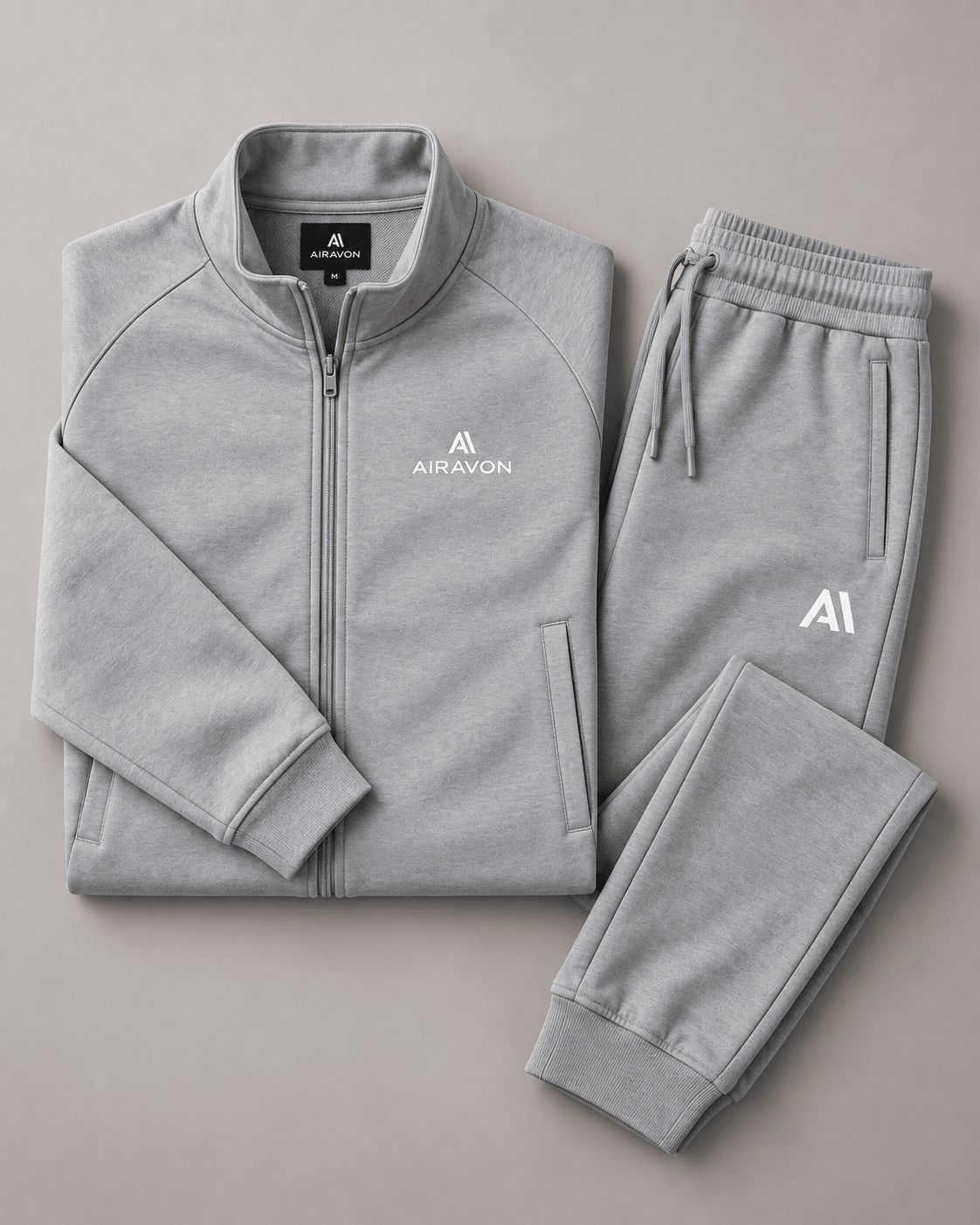 Airavon Light grey tracksuit jacket and trousers laid flat