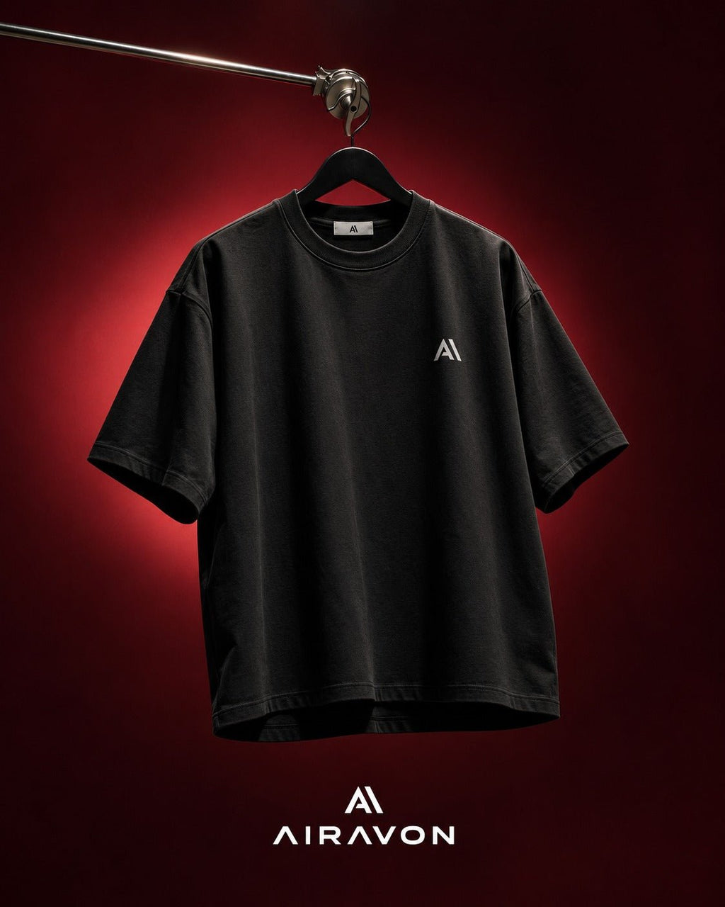 Airavon Black oversized T-shirt hanging against a red background
