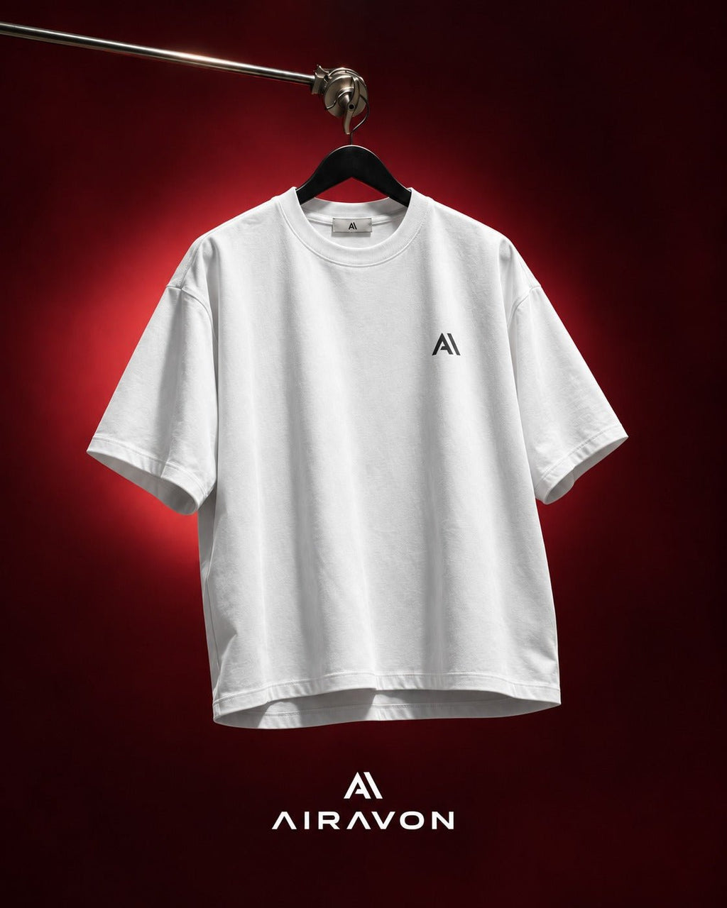 Airavon White oversized T-shirt hanging against a red background