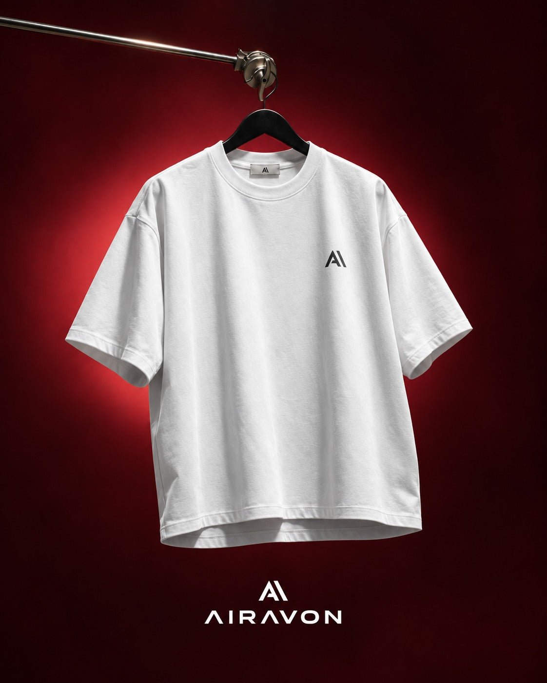 Airavon White oversized T-shirt hanging against a red background