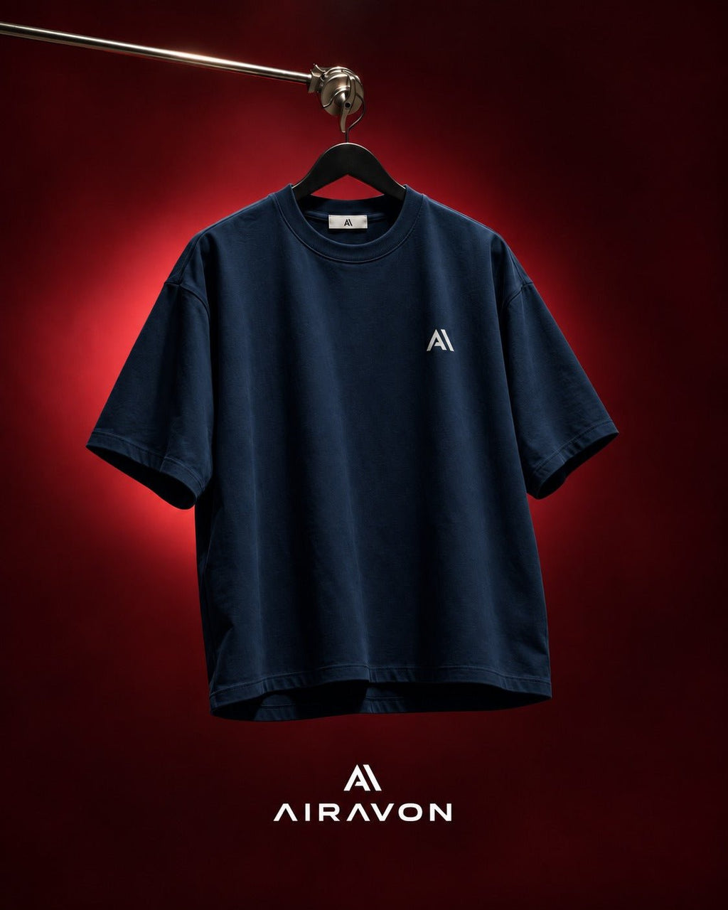 Airavon Navy oversized T-shirt hanging against a red background