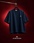 Airavon Navy oversized T-shirt hanging against a red background
