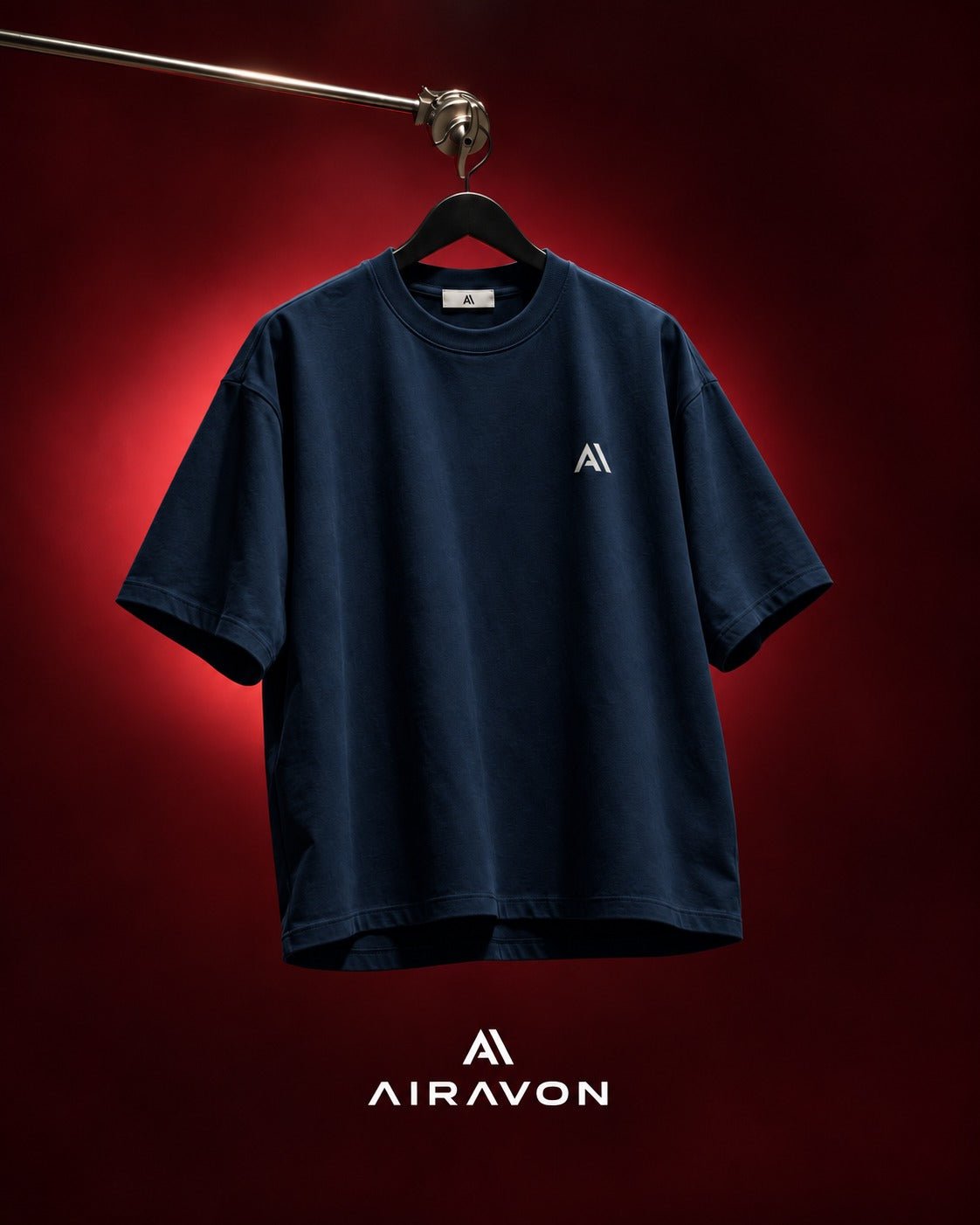 Airavon Navy oversized T-shirt hanging against a red background
