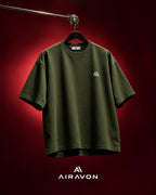 Airavon Olive green oversized T-shirt hanging against a red background